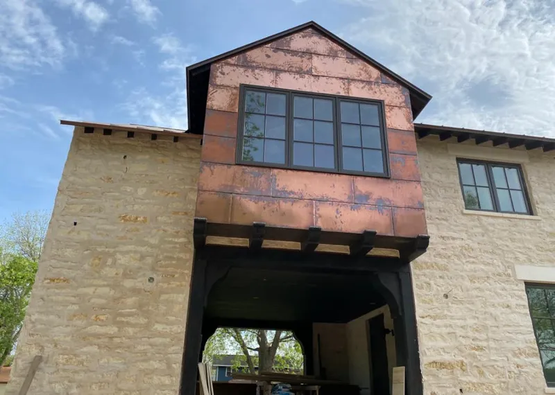 Copper metal panel facade on a stone building for Metal Roof Coating in Long Lake