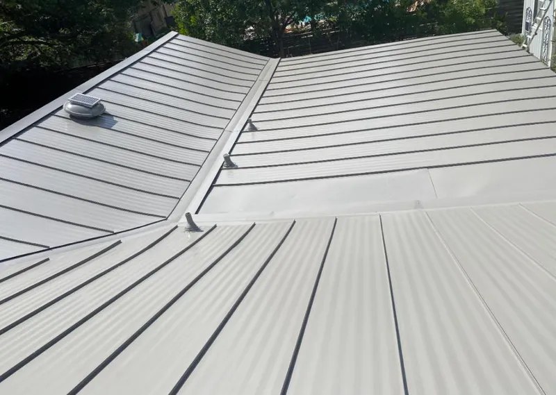 Solar attic fan installed on a metal roof for Roof Ventilation in Long Lake